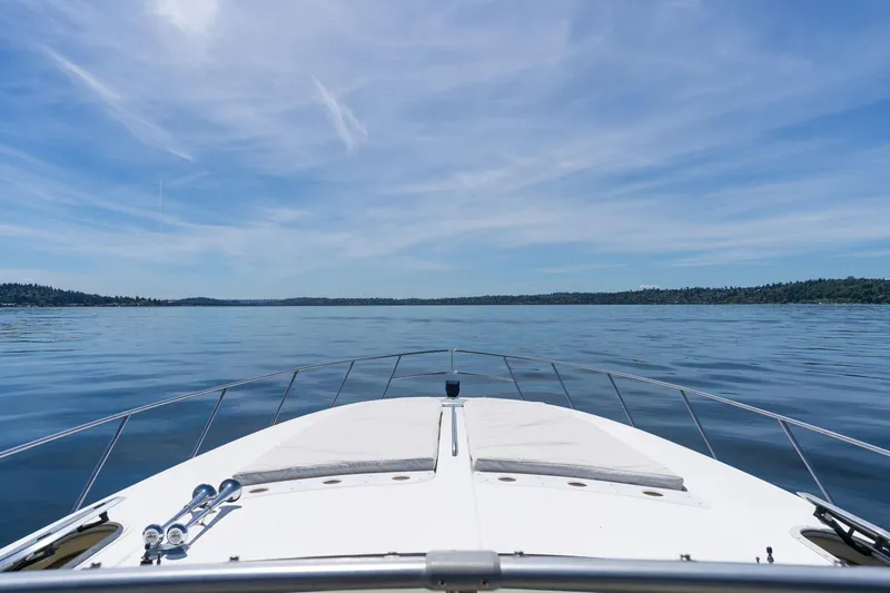Slide: The Image of Bow view of 1998 Avanti 4085 Sunbridge yacht on calm waters under blue sky. - 34