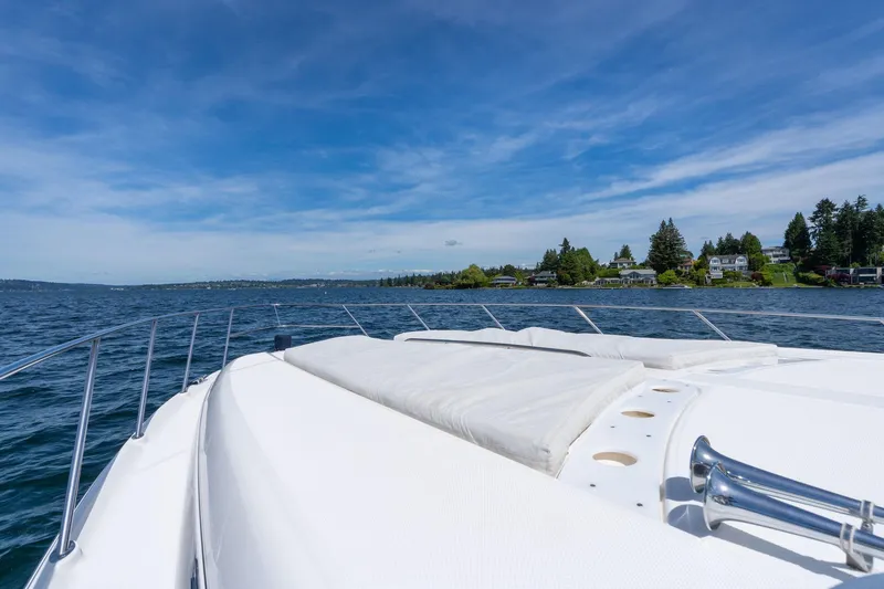 Slide: The Image of 1998 Avanti 4085 Sunbridge yacht cruising on a serene lake under a clear blue sky. - 37