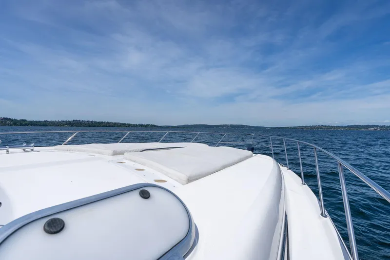 Slide: The Image of 1998 Avanti 4085 Sunbridge yacht cruising on open water under clear blue skies. - 40
