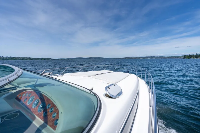 Slide: The Image of 1998 Avanti 4085 Sunbridge yacht cruising on a clear blue lake under a sunny sky. - 41