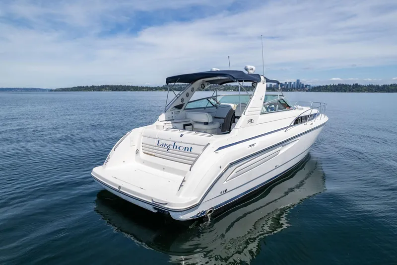 Slide: The Image of 1998 Avanti 4085 Sunbridge yacht on calm lake with city skyline. - 47