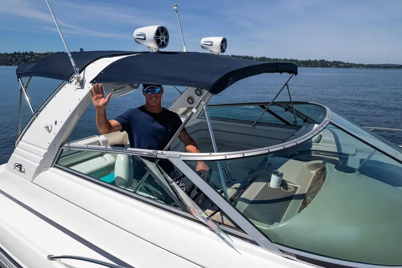 Slide: The Image of Man waving on a 1998 Avanti 4085 Sunbridge boat on a sunny day. - 63