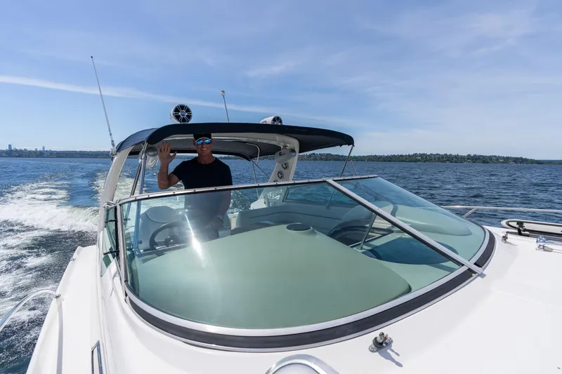 Slide: The Image of Man piloting 1998 Avanti 4085 Sunbridge boat on open water. - 64