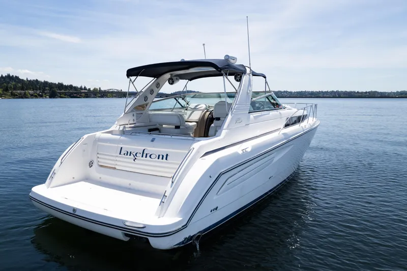 Slide: The Image of 1998 Avanti 4085 Sunbridge boat on a calm lake under a clear sky. - 65