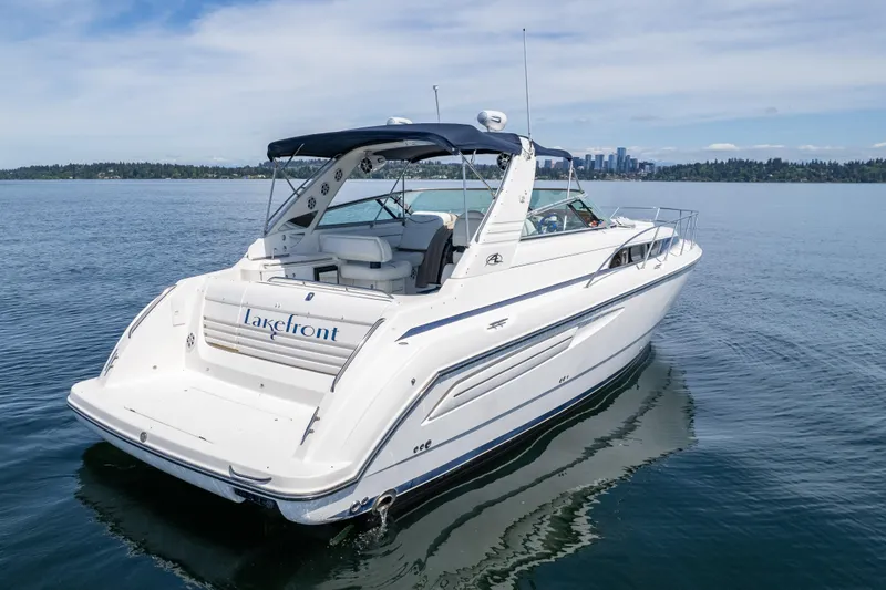 Slide: The Image of 1998 Avanti 4085 Sunbridge yacht on calm lake with city skyline. - 67