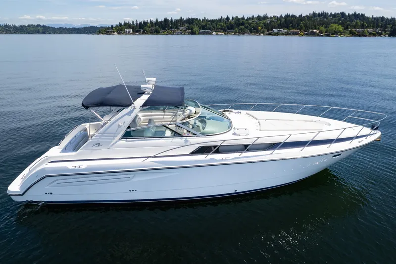 Slide: The Image of 1998 Avanti 4085 Sunbridge yacht on calm water, featuring sleek design and spacious deck. - 72