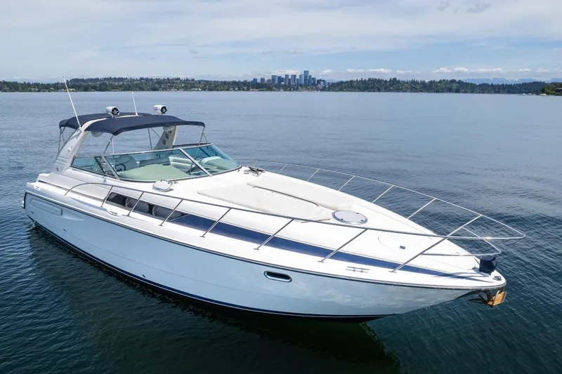 Slide: The Image of 1998 Avanti 4085 Sunbridge yacht on calm water with city skyline in background. - 73