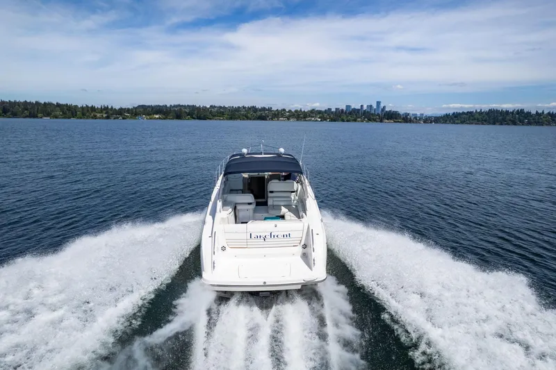 Slide: The Image of 1998 Avanti 4085 Sunbridge cruising on a lake with city skyline in background. - 75