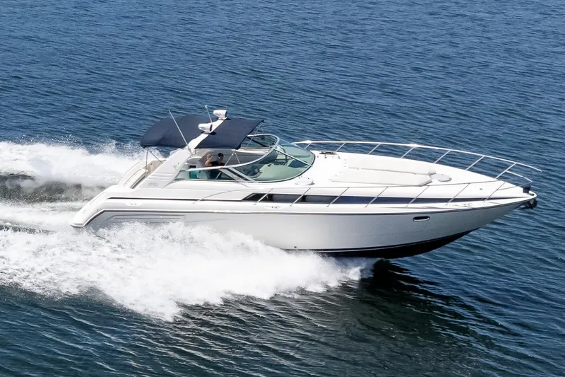 Slide: The Image of 1998 Avanti 4085 Sunbridge cruising on open water, showcasing sleek design and performance. - 76