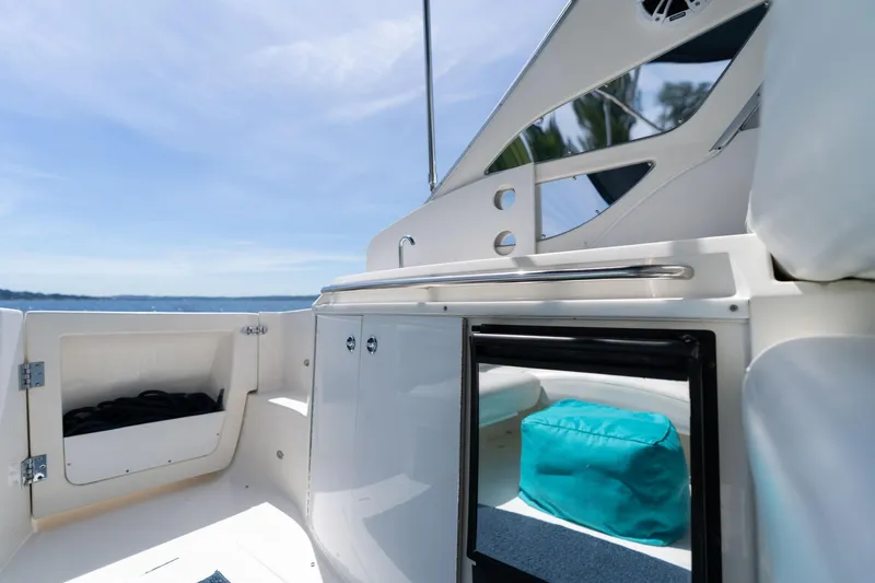 Slide: The Image of 1998 Avanti 4085 Sunbridge boat interior with open storage and blue sky background. - 9