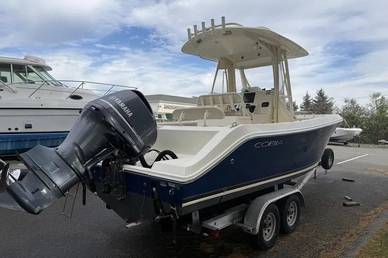 Slide: The Image of 2015 Cobia 237CC boat with Yamaha outboard motor on a trailer. - 1