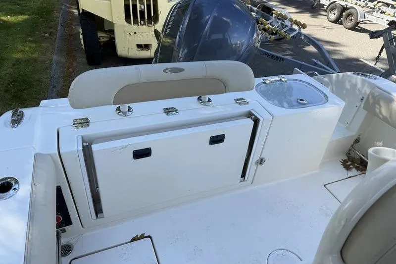 Slide: The Image of 2015 Cobia 237CC boat interior with storage compartments and seating. - 3