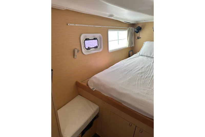 Slide: The Image of Interior cabin of 2015 Lagoon 380 S2 catamaran with bed and porthole window. - 11