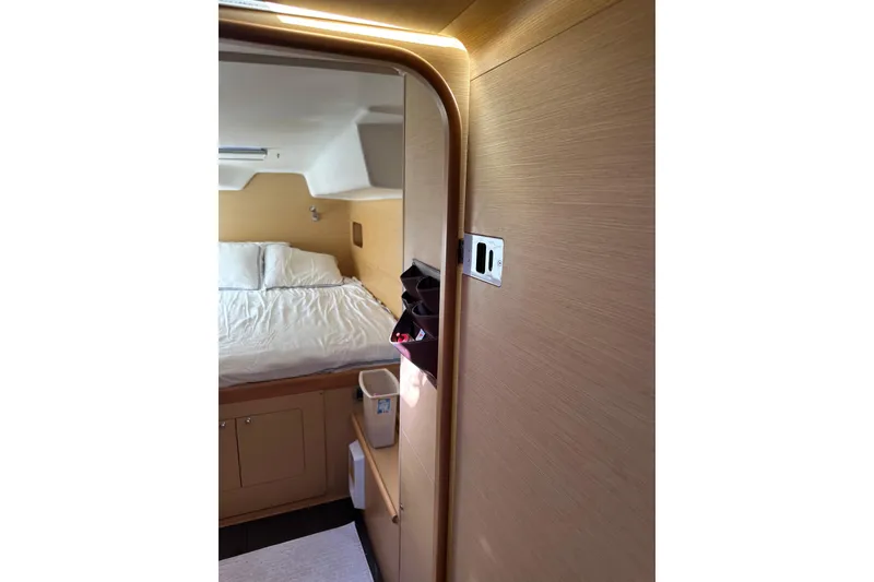 Slide: The Image of Cozy cabin interior of 2015 Lagoon 380 S2 catamaran with wooden finish and comfortable bed. - 12