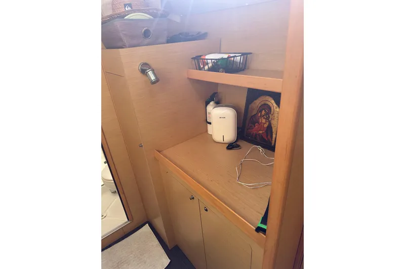 Slide: The Image of Interior of 2015 Lagoon 380 S2 yacht bathroom with wooden cabinetry and decor. - 13