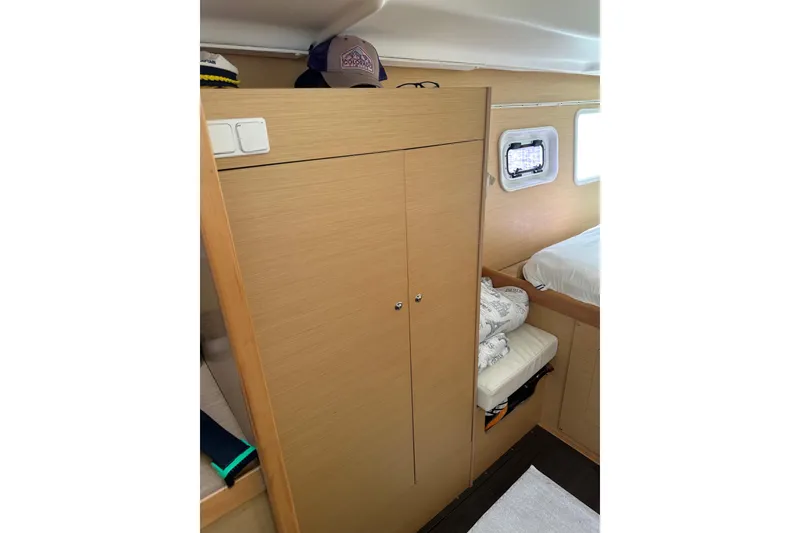 Slide: The Image of Interior cabin of 2015 Lagoon 380 S2 catamaran with wooden wardrobe and bed. - 14