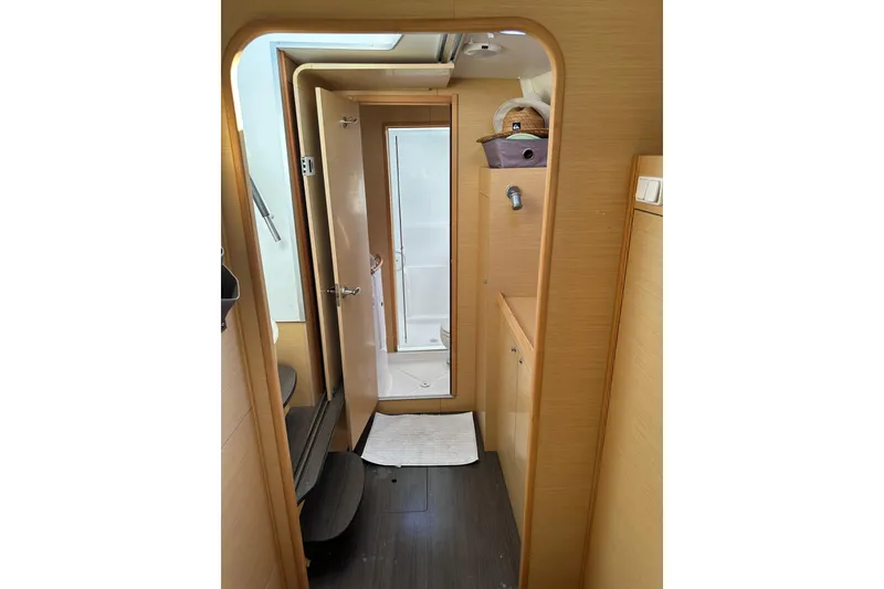 Slide: The Image of Interior of 2015 Lagoon 380 S2 yacht, featuring a compact bathroom. - 15