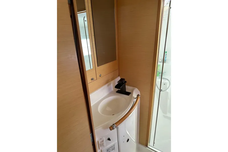 Slide: The Image of Compact bathroom in 2015 Lagoon 380 S2 yacht with modern sink and mirror. - 16