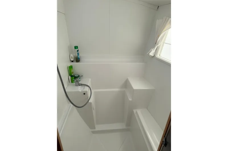 Slide: The Image of Bathroom interior of 2015 Lagoon 380 S2 yacht, featuring shower and toiletries. - 18