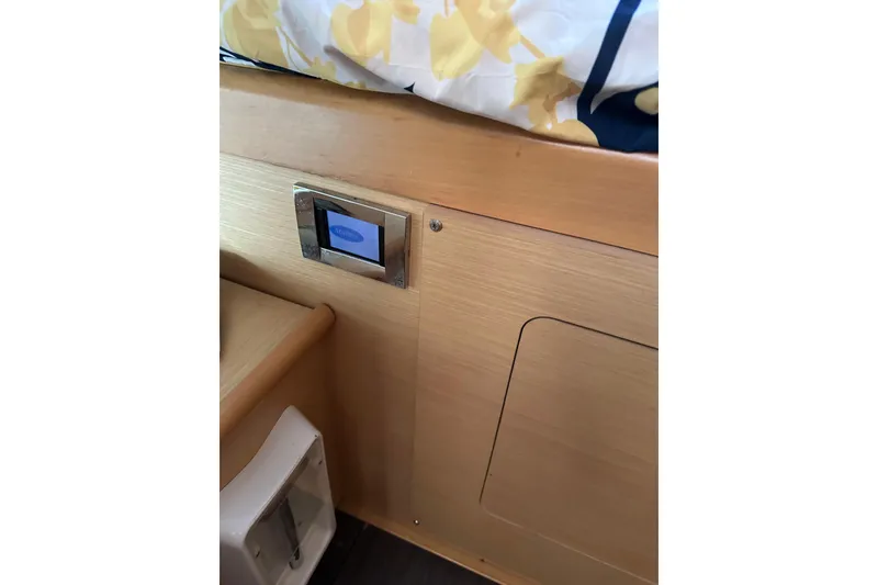 Slide: The Image of Interior of 2015 Lagoon 380 S2 yacht with wooden paneling and control panel. - 26