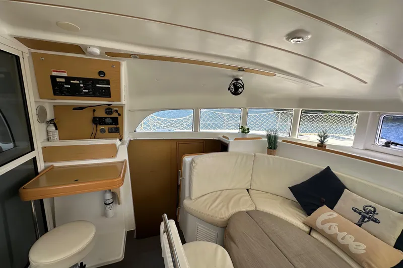 Slide: The Image of Interior of 2015 Lagoon 380 S2 catamaran with cozy seating and nautical decor. - 4