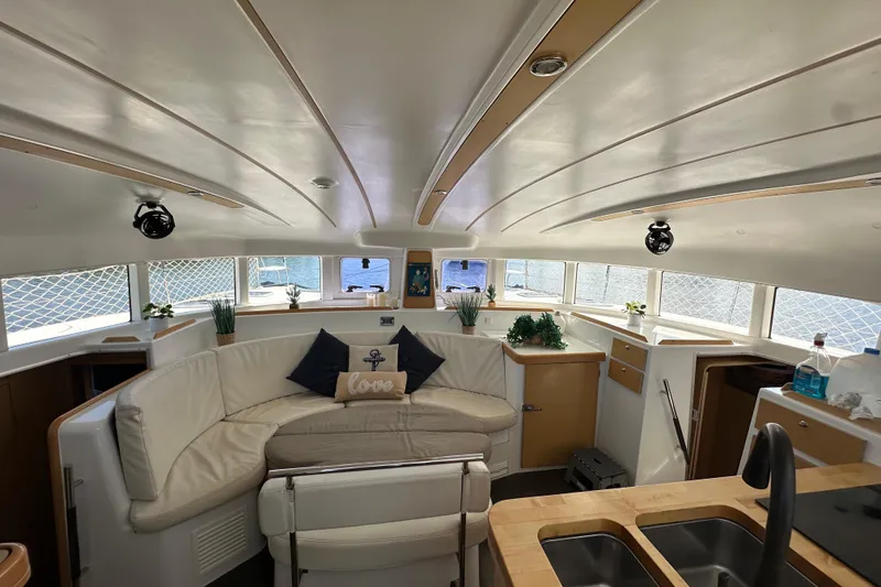 Slide: The Image of Interior of 2015 Lagoon 380 S2 catamaran with modern seating and decor. - 5
