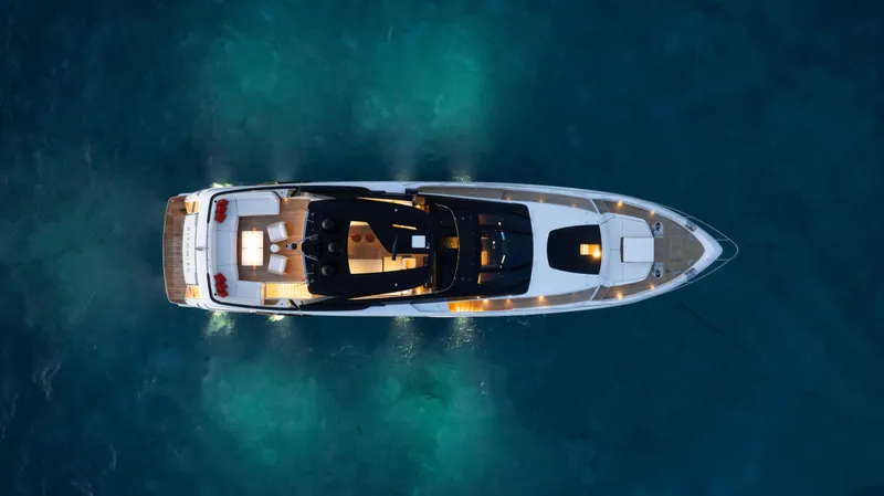 Slide: The Image of Aerial view of 2020 Riva 90 Argo yacht illuminated on blue water. - 10