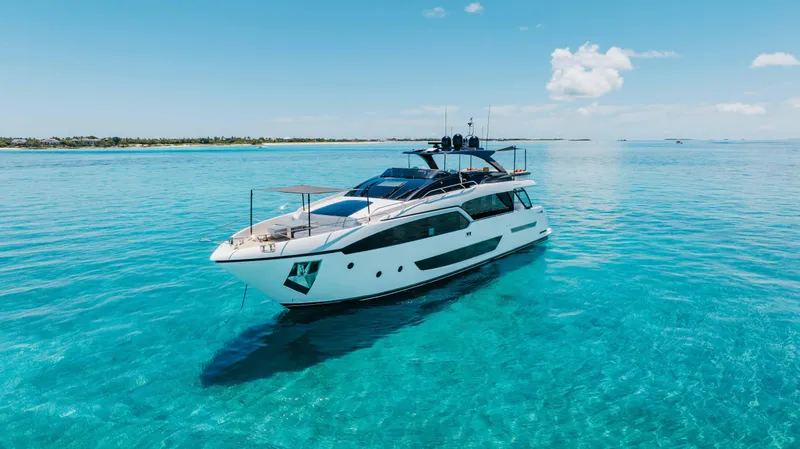 Slide: The Image of Luxurious 2020 Riva 90 Argo yacht cruising on clear turquoise waters. - 2