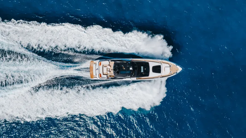 Slide: The Image of Aerial view of 2020 Riva 90 Argo yacht cruising on blue ocean waters. - 6