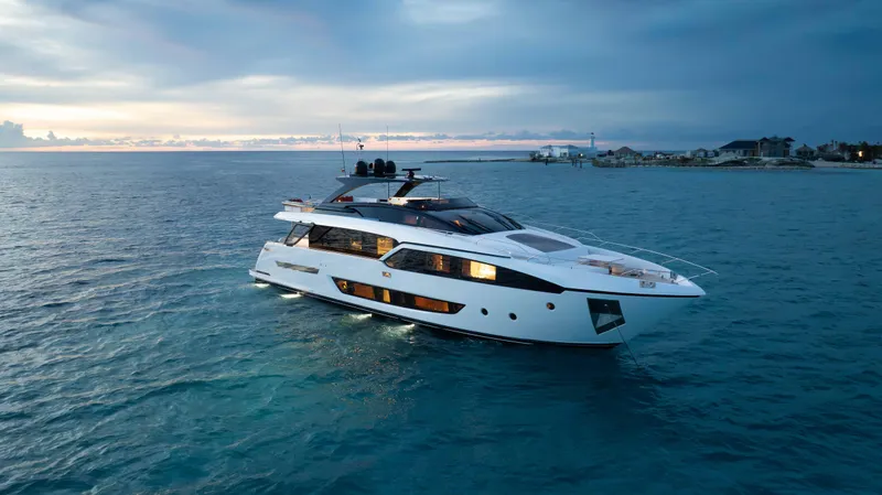 Slide: The Image of Luxurious 2020 Riva 90 Argo yacht cruising at sunset on tranquil waters. - 8
