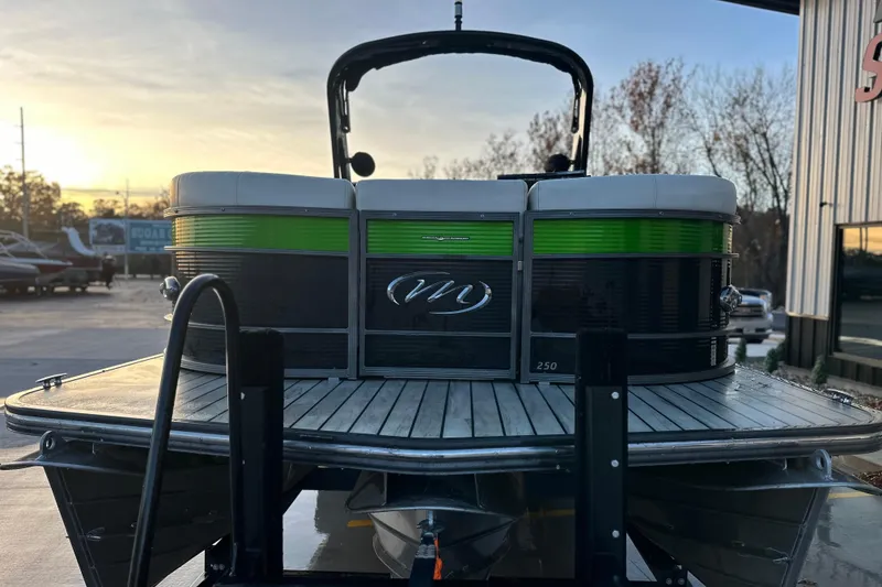 Slide: The Image of 2017 Manitou Xplode 250 pontoon boat on trailer at sunset. - 12