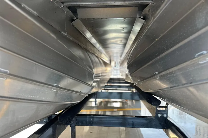 Slide: The Image of Underneath view of a 2017 Manitou Xplode 250 pontoon boat, showcasing aluminum pontoons. - 16