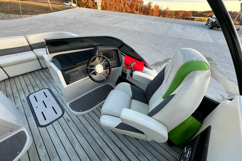 Slide: The Image of 2017 Manitou Xplode 250 boat interior with steering wheel and seating. - 17