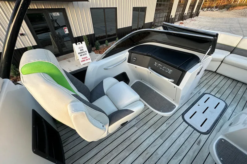 Slide: The Image of 2017 Manitou Xplode 250 boat interior with modern seating and sleek dashboard design. - 21