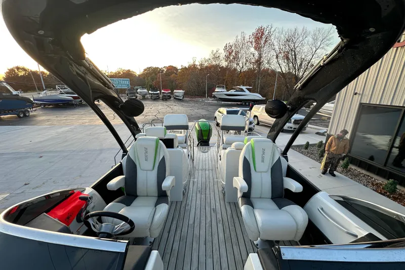 Slide: The Image of 2017 Manitou Xplode 250 pontoon boat interior with modern seating and steering wheel. - 22