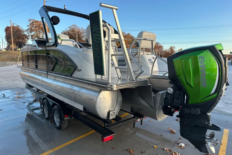 Slide: The Image of 2017 Manitou Xplode 250 pontoon boat with Evinrude outboard motor on trailer. - 6