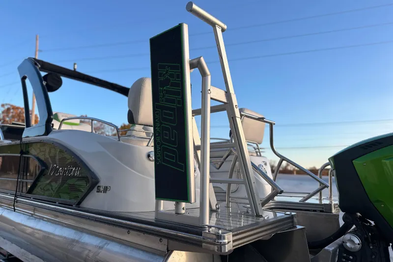 Slide: The Image of 2017 Manitou Xplode 250 pontoon boat with diving board, docked on a sunny day. - 7