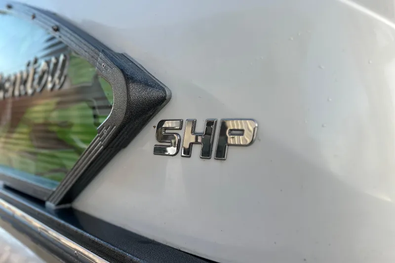 Slide: The Image of 2017 Manitou Xplode 250 boat emblem with SHP badge on white surface. - 8