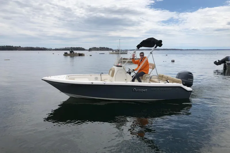 Slide: The Image of 2018 Key West 189 FS boat on calm water with a person waving. - 4