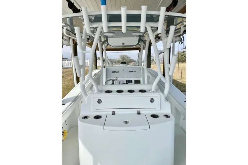 Slide: The Image of 2018 Yellowfin 36 Offshore boat console with Simrad electronics and steering wheel. - 12