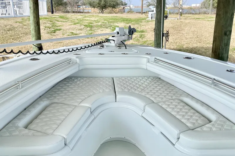 Slide: The Image of 2016 Yellowfin 36 Offshore boat with vibrant "Gulf Bandit" design, docked in serene waters. - 3