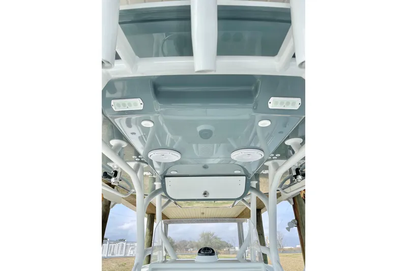 Slide: The Image of 2018 Yellowfin 36 Offshore boat interior with cushioned seating and speakers. - 8
