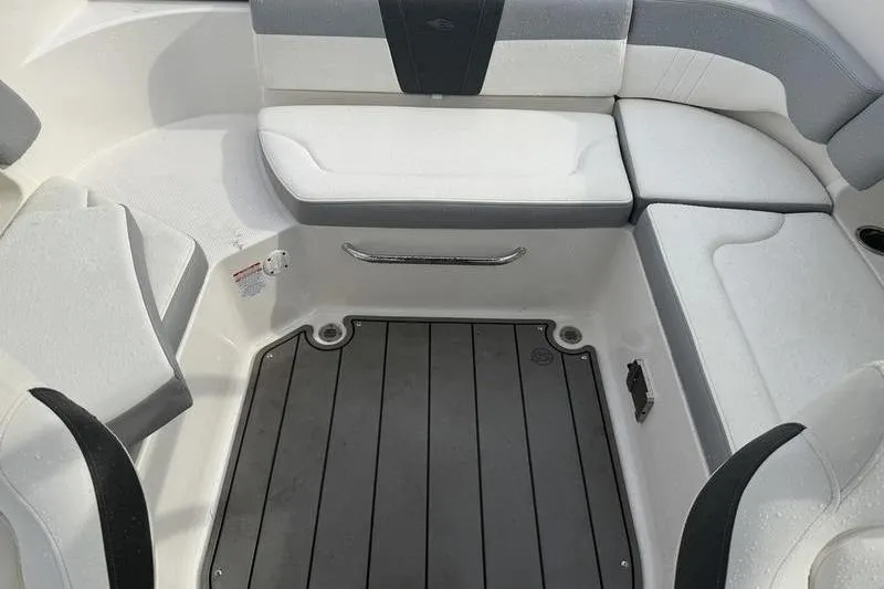 Slide: The Image of 2023 Chaparral 23 SSi boat interior with cushioned seating and non-slip flooring. - 2