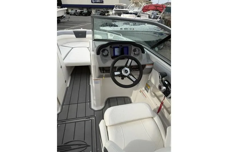 Slide: The Image of 2023 Chaparral 23 SSi boat interior with steering wheel and dashboard controls. - 3