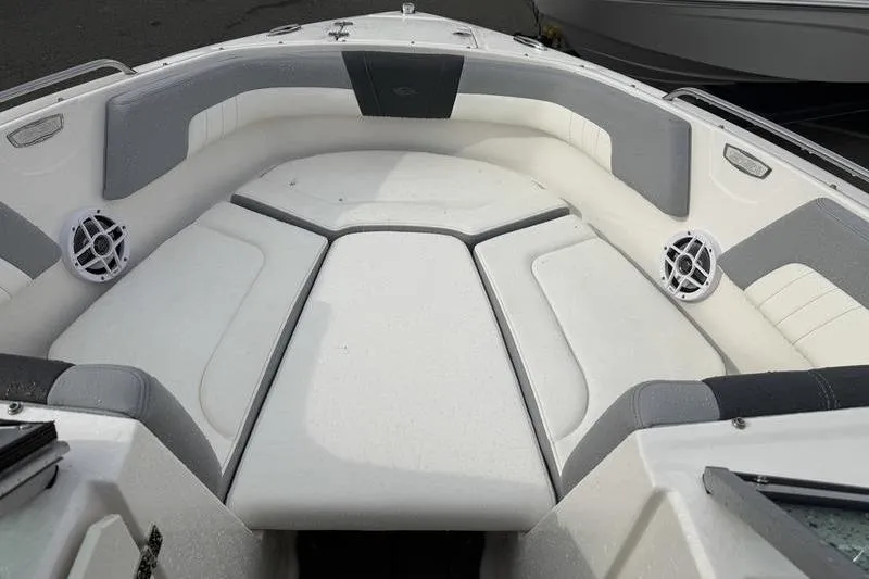 Slide: The Image of 2023 Chaparral 23 SSi boat interior with white seating and gray flooring. - 9