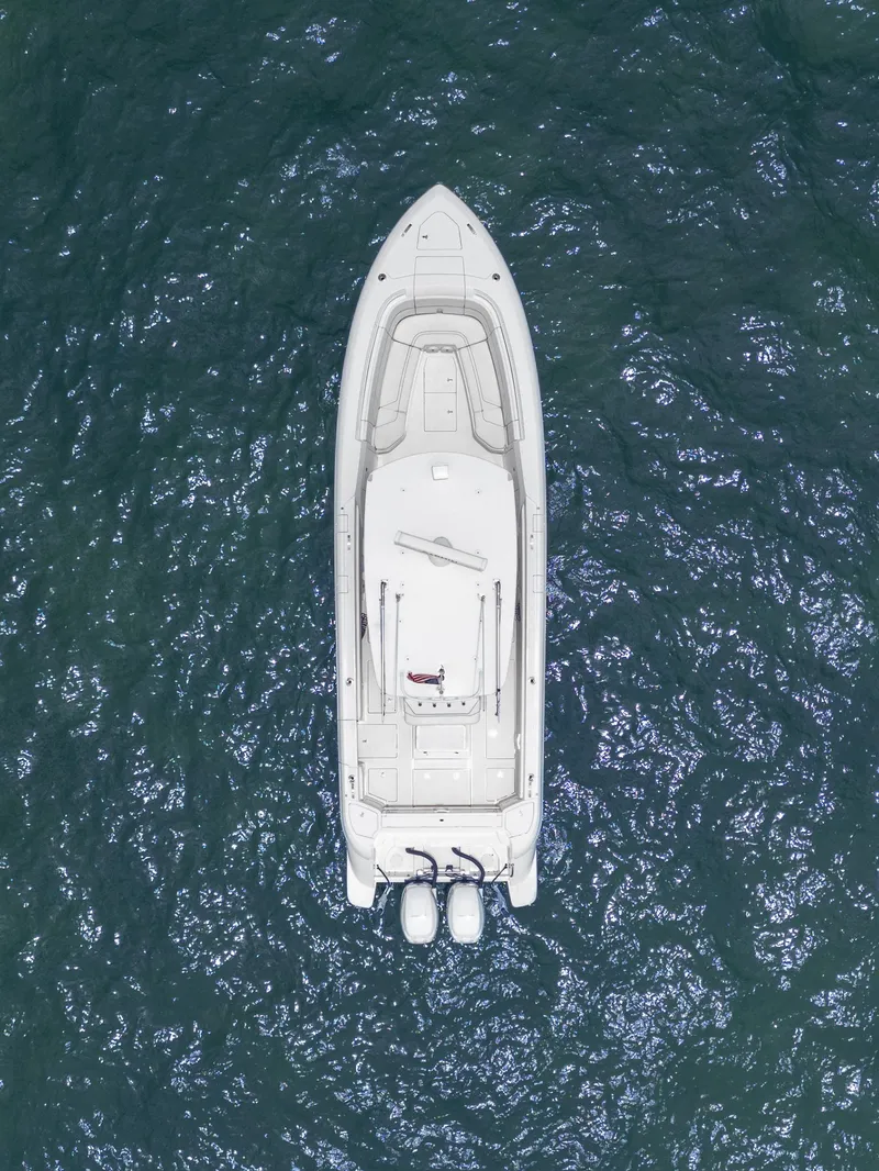 Slide: The Image of Aerial view of 2021 Intrepid 345 Nomad FE boat on open water. - 15