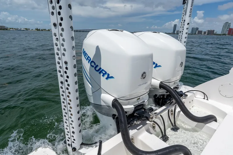 Slide: The Image of Twin Mercury outboard engines on a 2021 Intrepid 345 Nomad FE boat in open water. - 17