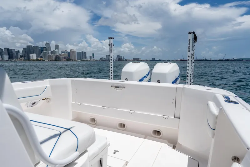 Slide: The Image of 2021 Intrepid 345 Nomad FE boat with twin Mercury engines, city skyline in background. - 19