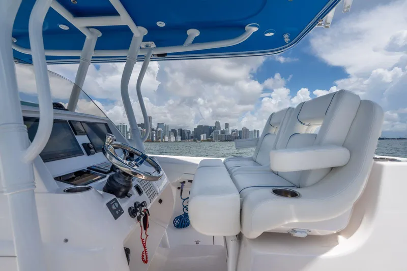 Slide: The Image of 2021 Intrepid 345 Nomad FE boat interior with city skyline in background. - 2
