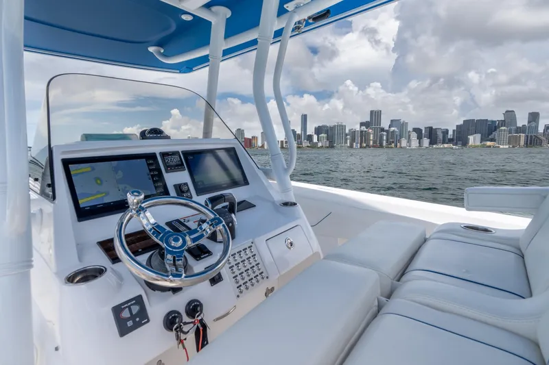 Slide: The Image of 2021 Intrepid 345 Nomad FE boat cockpit with city skyline in background. - 30